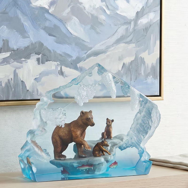 Lucite sculpture of bears on an iceberg with a mountainous background
