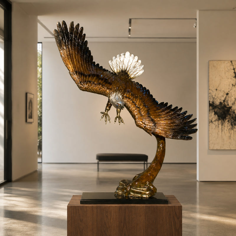 Large bronze eagle statue on black marble base. Gallery setting
