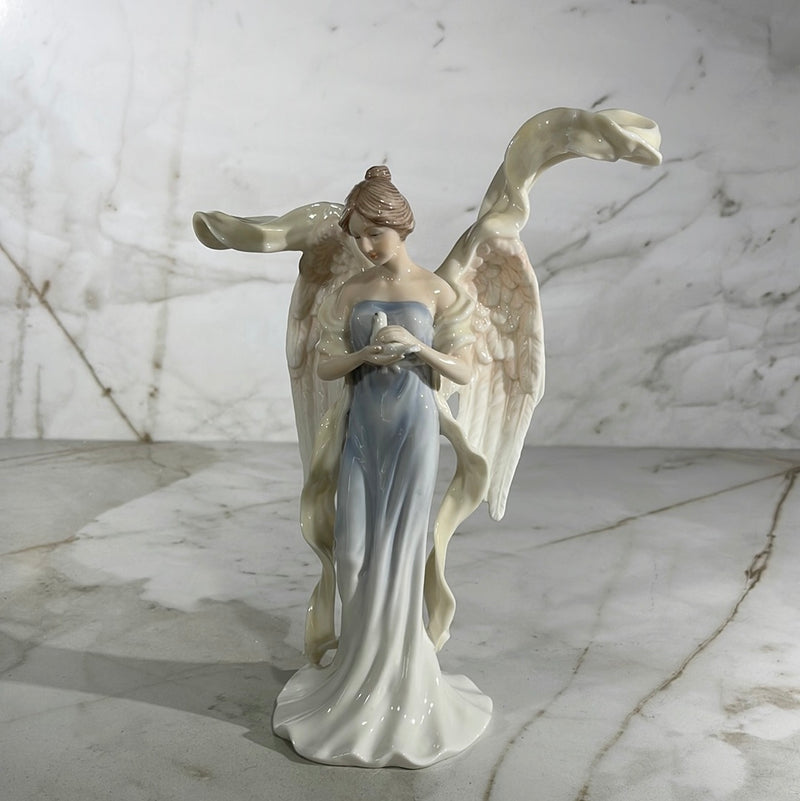 Angel holding dove statue 