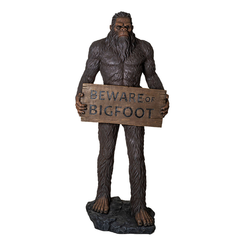 Statue of a Sasquatch holding a 'Beware of Bigfoot' sign on a white background