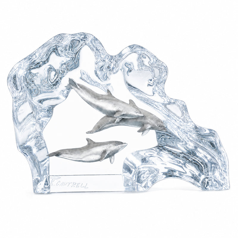 Lucite sculpture of dolphins and waves on a white background. Created by Kitty Cantrell. Made by Starlite Originals. Title: Dolphin Wave