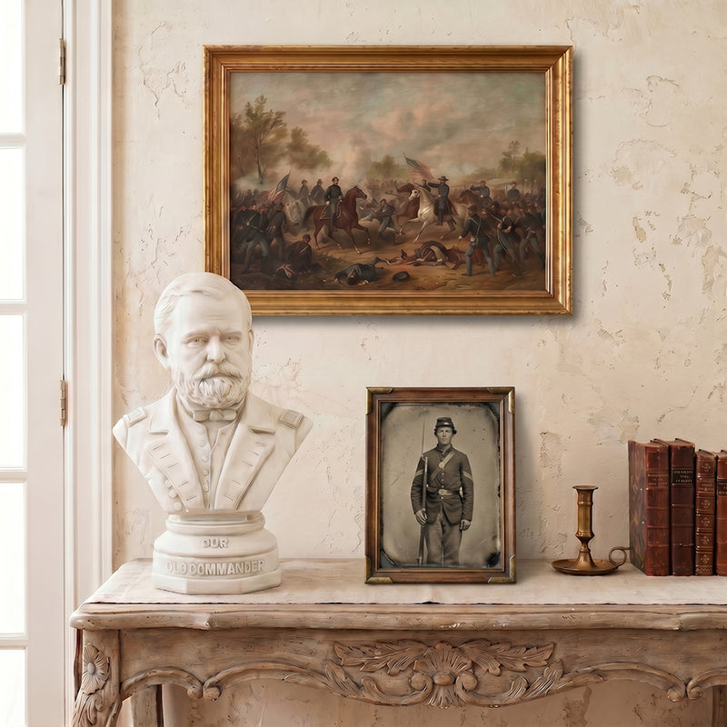 General Ulysses S. Grant bust, framed painting of a Civil War battle, and books on a decorative table against a wall with a framed tin type photo of a US Civil war soldier.