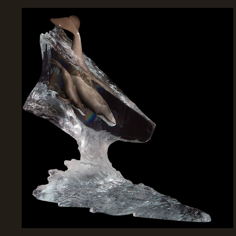 A sculpture of a mother whale and her calf crafted from polished Lucite with hand-painted hot wax patinas, appearing to be in motion.