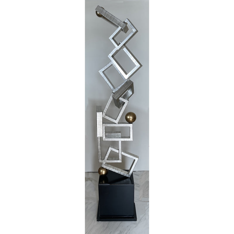 geometric floor sculpture in silver, gold and black