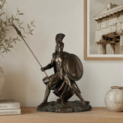 Spartan warrior table top statue in cold cast bronze. positioned on light wood shelf