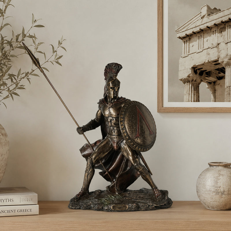 Spartan warrior table top statue in cold cast bronze. positioned on light wood shelf