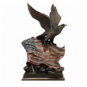 Bronze like statue of an eagle on an American flag with a white background