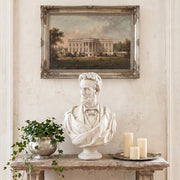 Bust of Abraham Lincoln on a table with a painting of 18th Century White House, in a French Country room setting.