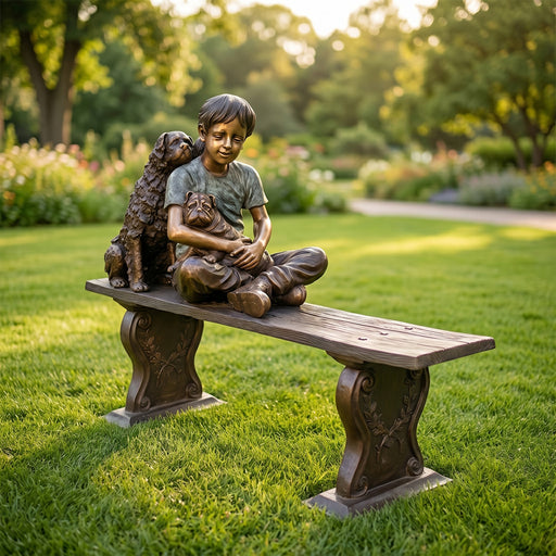 Bronze statue of a boy with two dogs sitting on a bench in a garden.