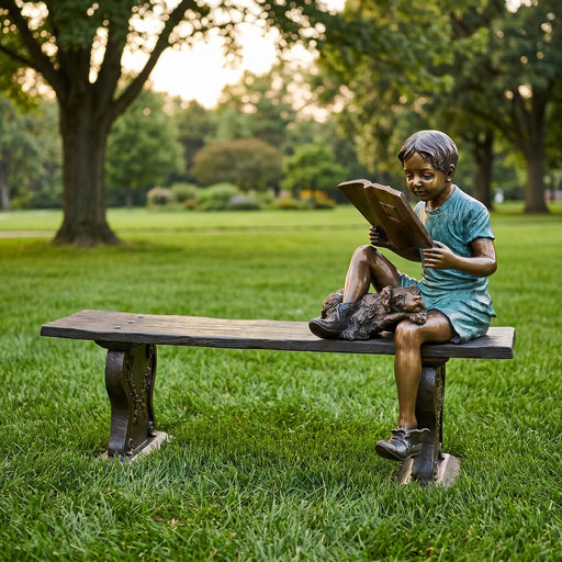 Statue of a child reading a book on a bench in a park setting