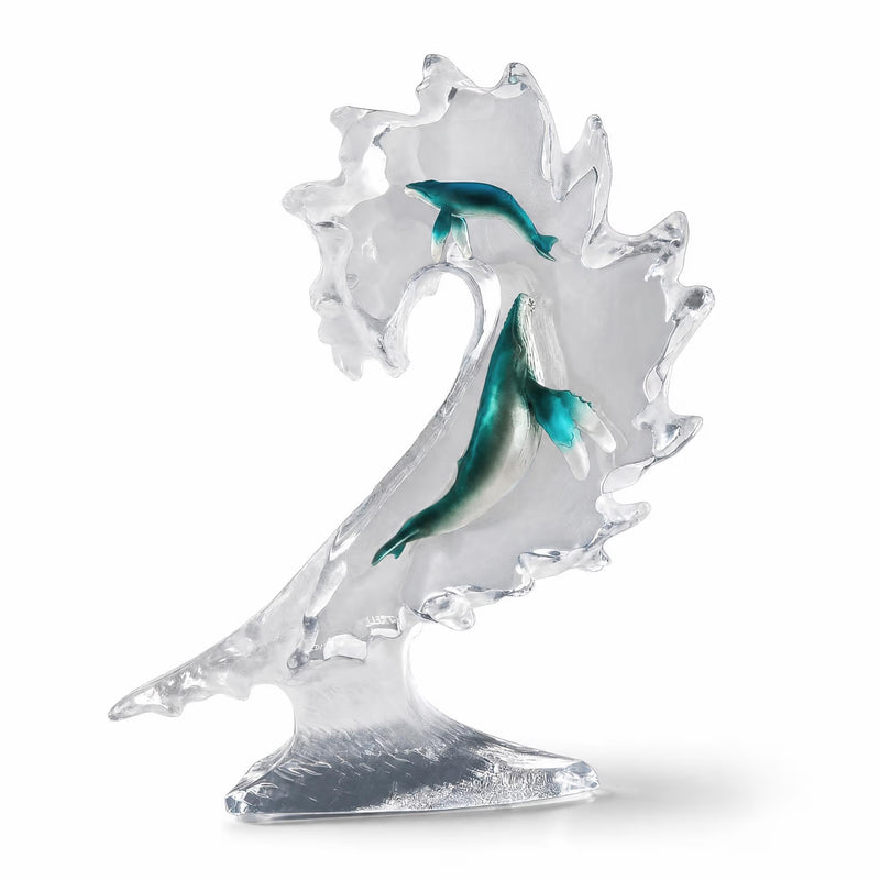 Glass sculpture of a whale with a white background