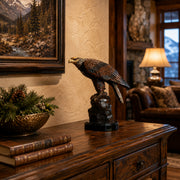 Table top statue of a bronze eagle perched on rock. Lodge interior design