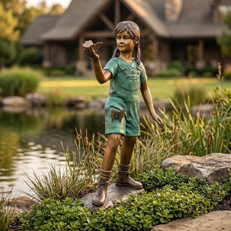 bronze statue of a girl holding a butterfly in her hand. garden statue.