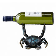 Crab-shaped wine bottle holder with a green wine bottle on a white background