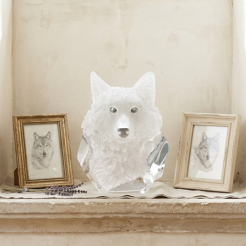 Wolf head sculpture on a shelf with framed wolf portraits