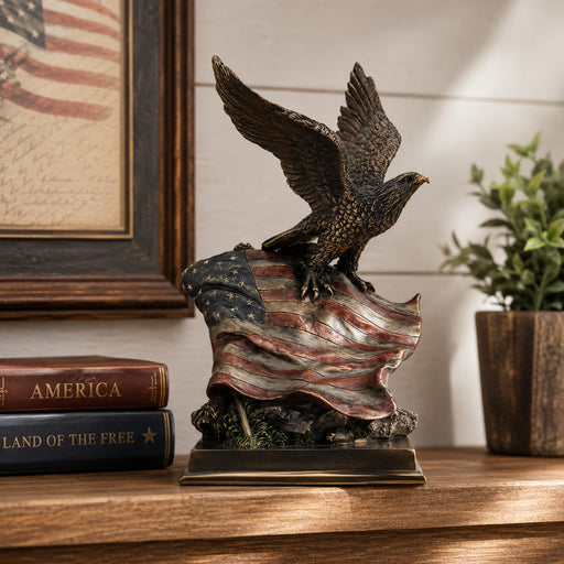 Bronze like eagle statue on an American flag with books and a plant in the background