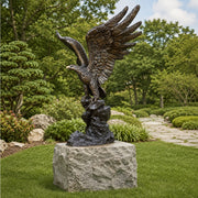 large bronze eagle statue in outdoor park setting on granite plinth