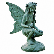Statue of a garden fairy with wings on a white background