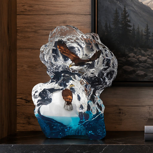 Decorative sculpture of an eagle in a natural setting with a mountain and forest painting in the background.