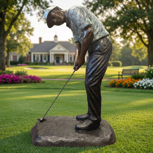 Bronze statue of a golfer on a golf course with a clubhouse in the background