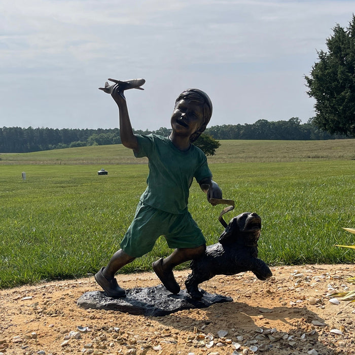 Boy with airplane statue