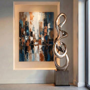 large abstract sculpture with modern painting behind in room