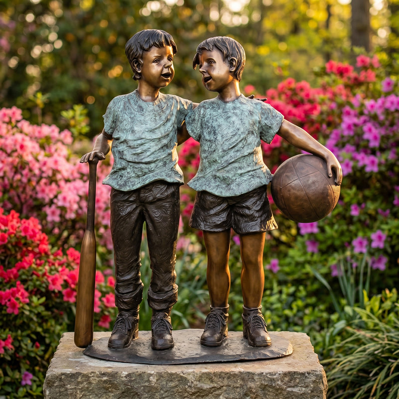 Bronze statue of two children with sports equipment in a garden setting