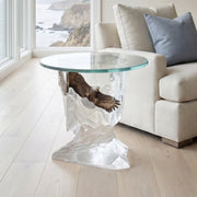 Clear glass table with a unique base design with bald eagle in a living room setting.