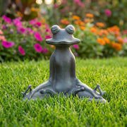 meditating frog garden statue on grass