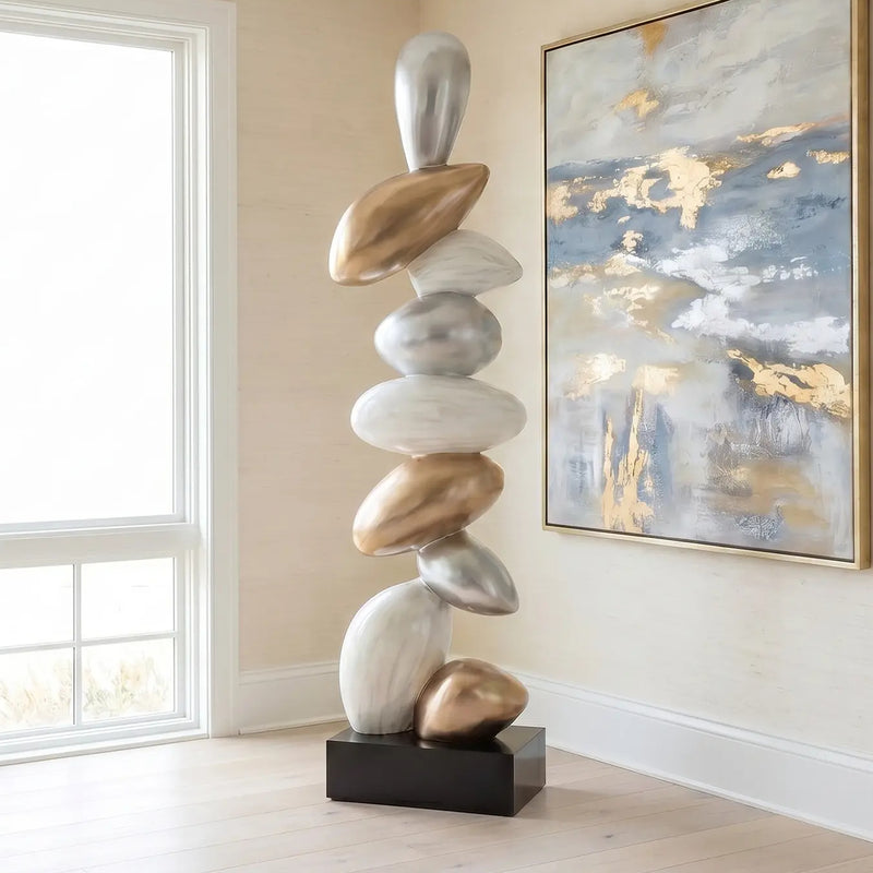 Modern floor sculpture in beach house living room with gold, white and black finish. Abstract painting 