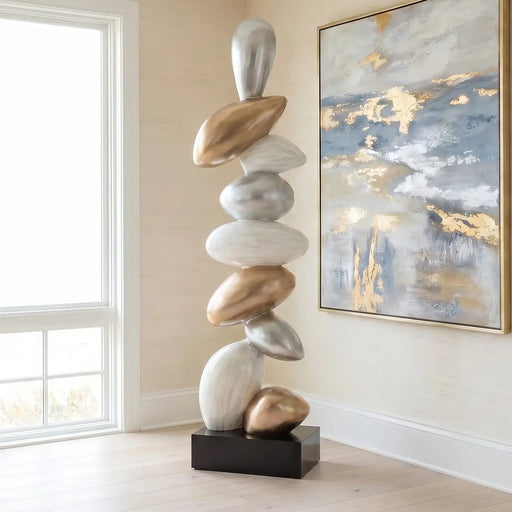 Modern floor sculpture in beach house living room with gold, white and black finish. Abstract painting 