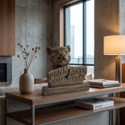 Bronze Penn Statue statue with on a wooden sofa table in a modern room.