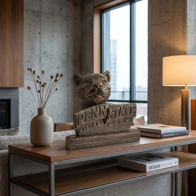 Bronze Penn Statue statue with on a wooden sofa table in a modern room.