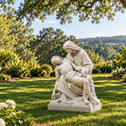 Pieta garden statue in outdoor setting under tree