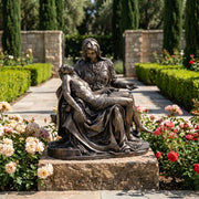 Pieta Sculpture in garden setting surrounded by roses