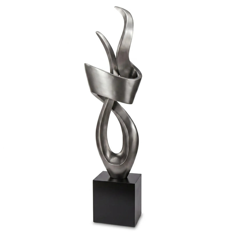 Abstract metal sculpture on a black base against a white background