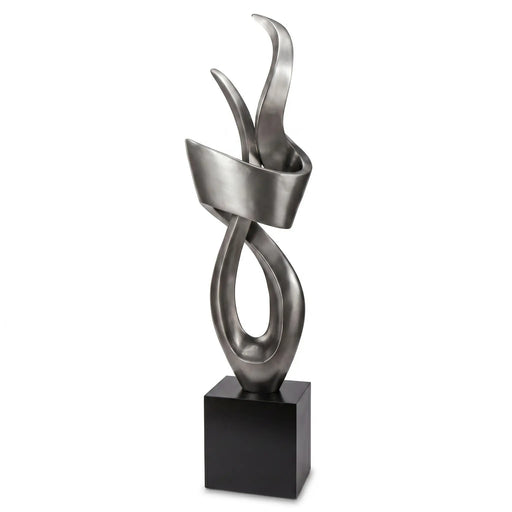 Abstract metal sculpture on a black base against a white background