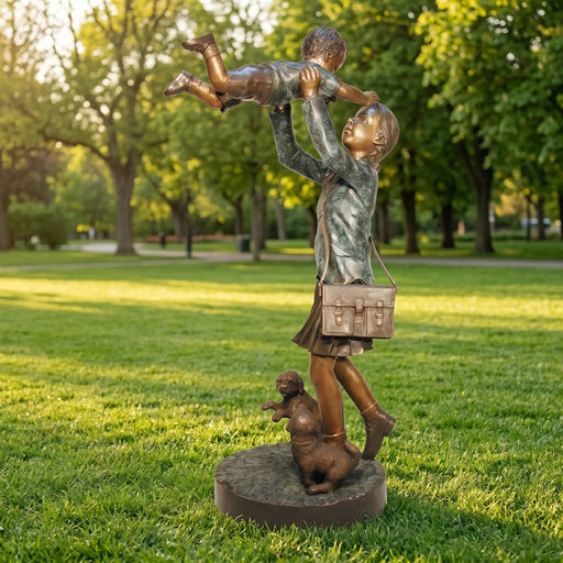 Bronze statue of a sister holding her brother in a park setting