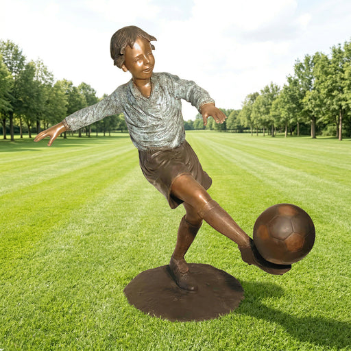 boy kicking soccer ball statue