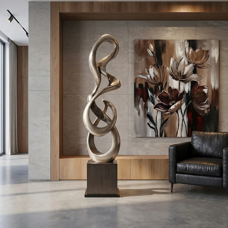 Decorative standing sculpture in a modern living room with a painting on the wall.