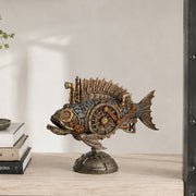 Steampunk fish sculpture on a decorative stand, styled on a light wood shelf next to stacked books against a neutral wall.