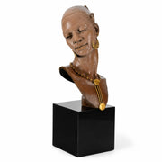 Bust of a African Female wearing gold jewelry on a black cube. Artist Thomas Blackshear