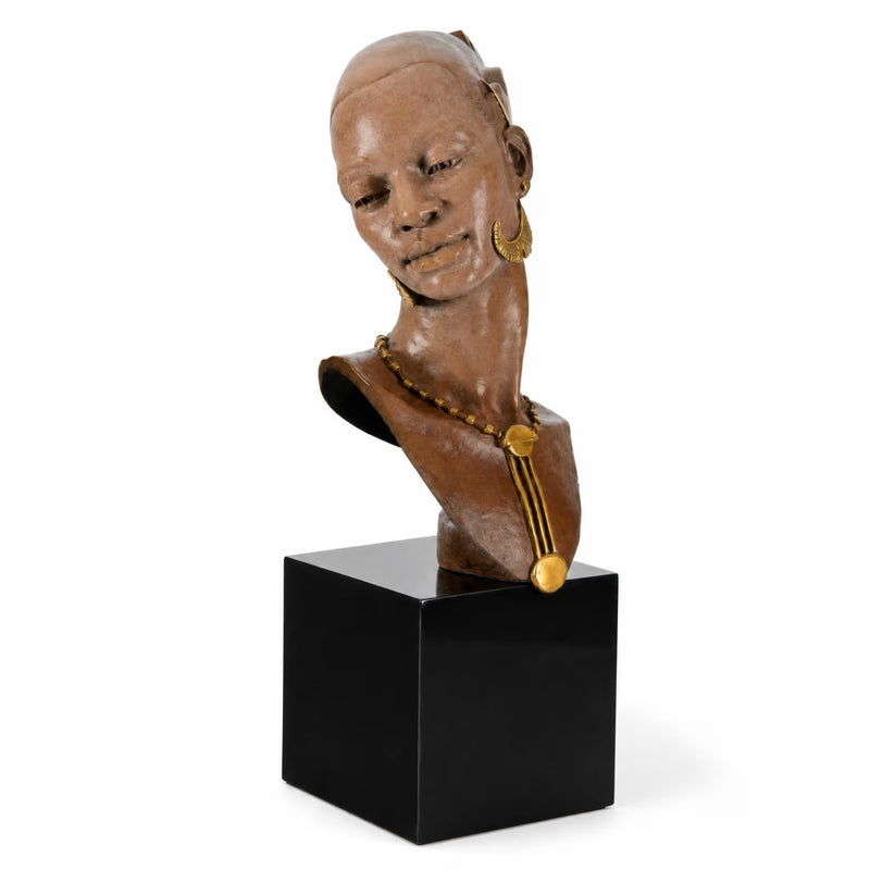 Bust of a African Female wearing gold jewelry on a black cube. Artist Thomas Blackshear