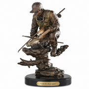 bronze like statue of a fisherman with trout. Title: Until We Meet Again. Artist: Marc Pierce