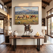 Living room with a large painting of horses in a field, a Native American Indian statue on a wooden table, and decorative items.