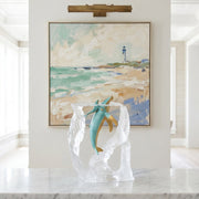 Breath of Life Whale Sculpture by Kitty Cantrell. Positioned on white marble table with abstract painting in background